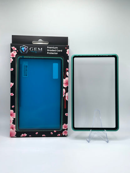 Light Green Gem Protectors magnetic PSA slab case standing upright on a clear stand next to its retail box