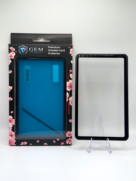 Black Gem Protectors magnetic PSA slab case standing upright on a clear stand next to its retail box