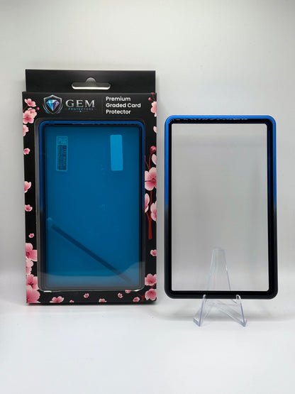 Black & Blue Gem Protectors magnetic PSA slab case standing upright on a clear stand next to its retail box