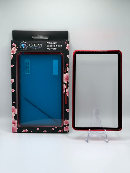 Red Gem Protectors magnetic PSA slab case standing upright on a clear stand next to its retail box