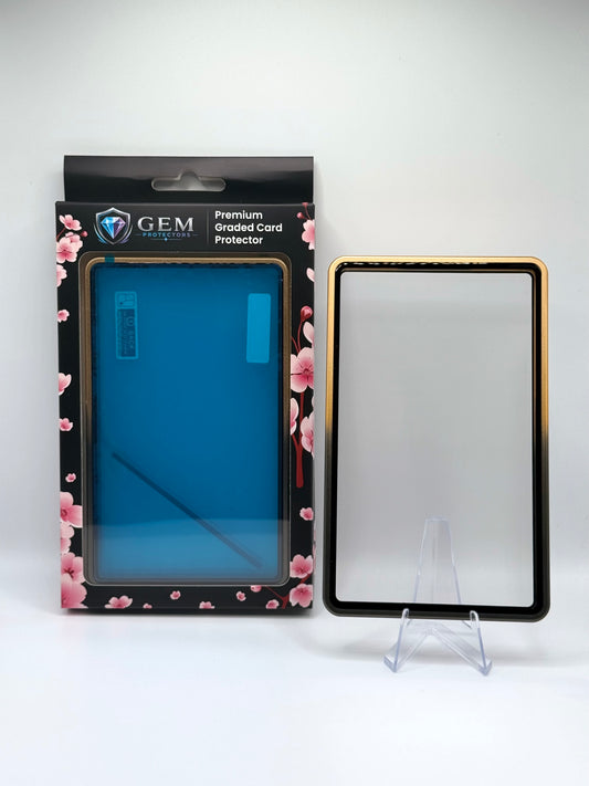Black & Gold Gem Protectors magnetic PSA slab case standing upright on a clear stand next to its retail box