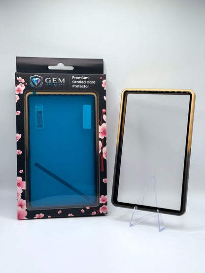 Front view of the empty Black & Gold Gem Protectors case showing the frame and clear panel, beside its retail box