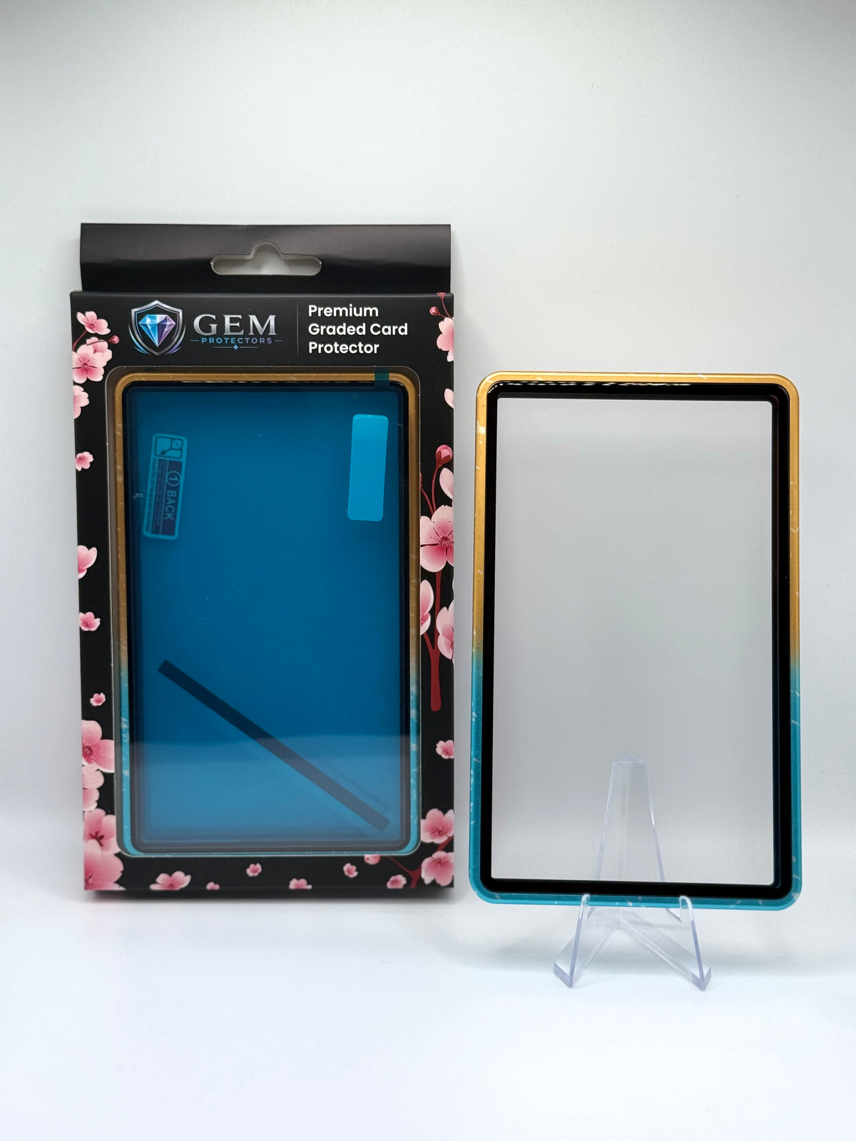 Blue & Yellow Sparkle Gem Protectors magnetic PSA slab case standing upright on a clear stand next to its retail box