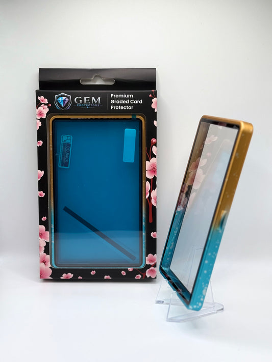 Blue & Yellow Sparkle Gem Protectors case angled on a clear stand to show the frame's side profile, next to its retail box