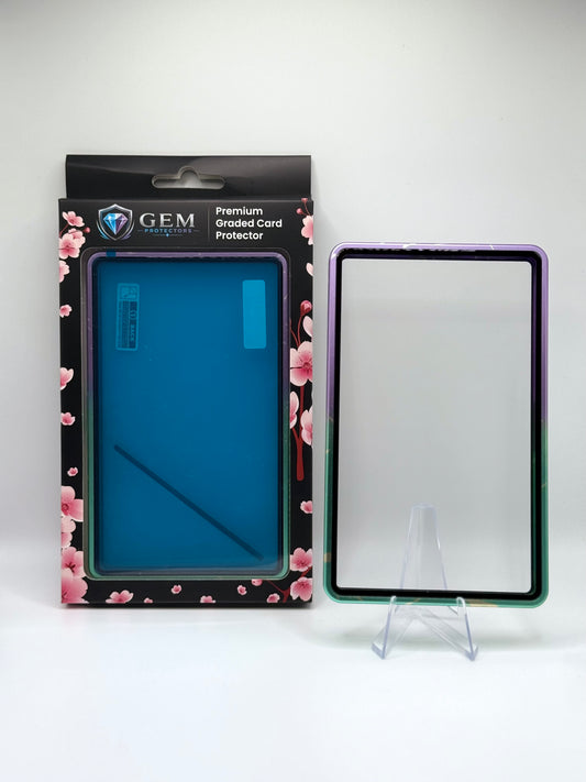 Cyan & Purple Sparkle Gem Protectors magnetic PSA slab case standing upright on a clear stand next to its retail box