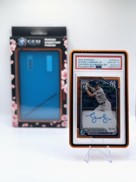 Orange Gem Protectors case holding an autographed PSA-graded baseball card, displayed on a clear stand