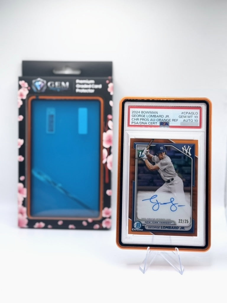 Orange Gem Protectors case holding an autographed PSA-graded baseball card, shown beside its retail box