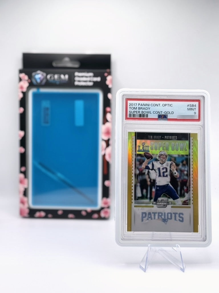 Porcelain White Gem Protectors case holding a PSA-graded Tom Brady Patriots card, displayed on a clear stand