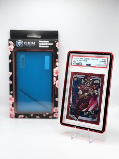Red Gem Protectors case holding a PSA-graded Jayden Daniels football card, shown beside its retail box