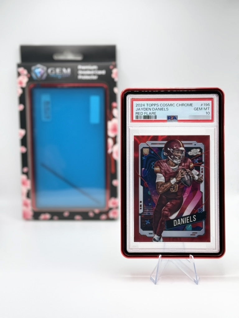 Red Gem Protectors case holding a PSA-graded Jayden Daniels football card, displayed on a clear stand